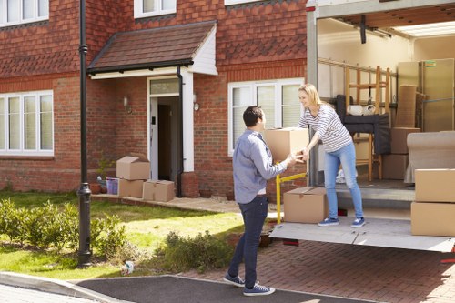 Packers wrapping fragile items for a high-value home move